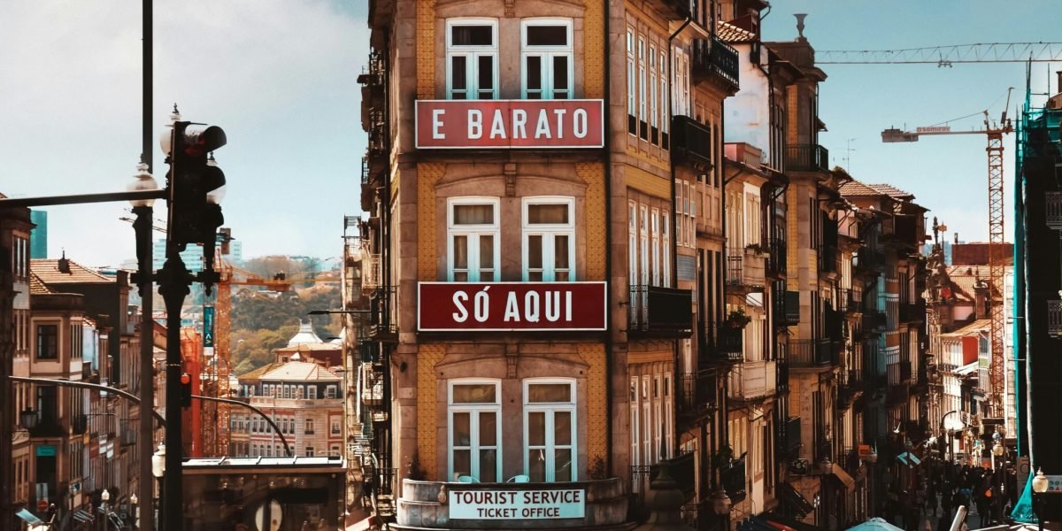 Vibrant street view of Porto with historical architecture and lively pedestrian activity.